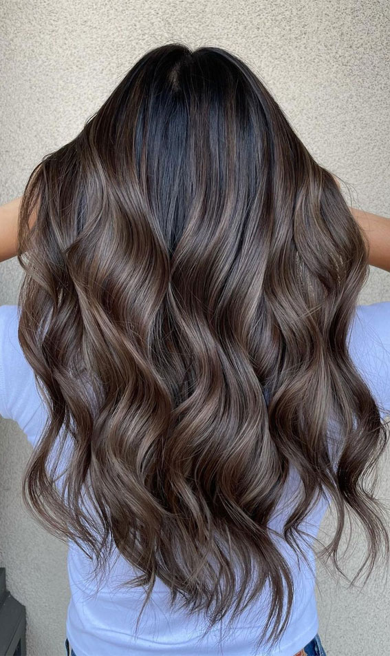 Long wavy ash brown hair with dark shadow roots