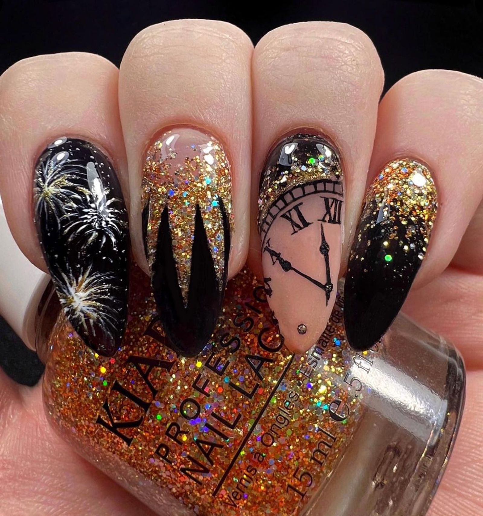 Long stiletto nails with silver fireworks, gold glitter and a clock face nearing midnight