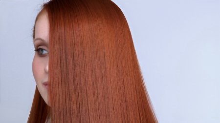 Copper red one-length long straight hair with middle part, side view
