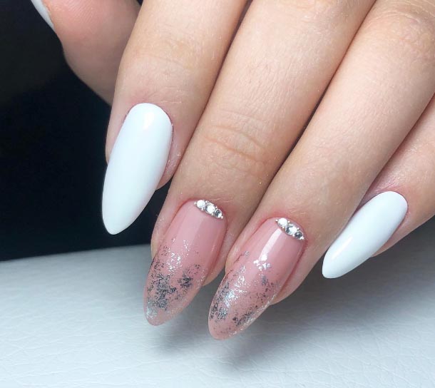 Pink almond nails with white accent nails, silver glitter gradients and crystal lines at the cuticle