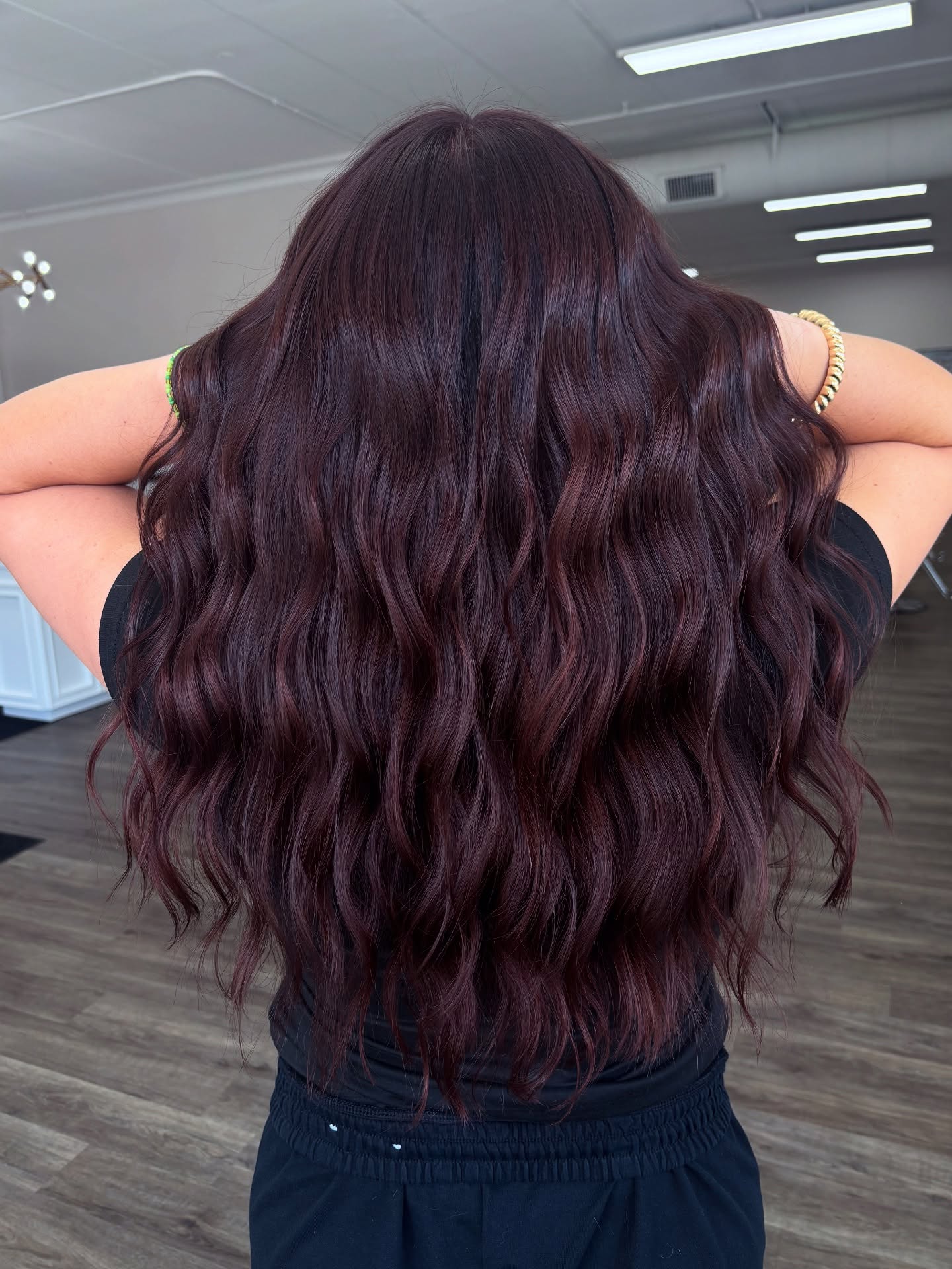 Voluminous long waves in deep merlot wine red hair color