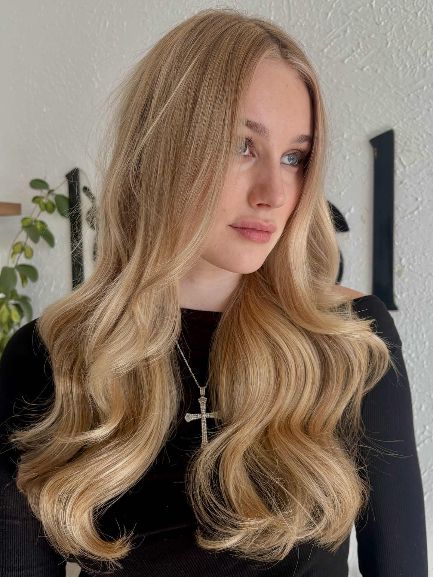 Luxurious golden blonde waves cascading with vintage glamour and deep shine