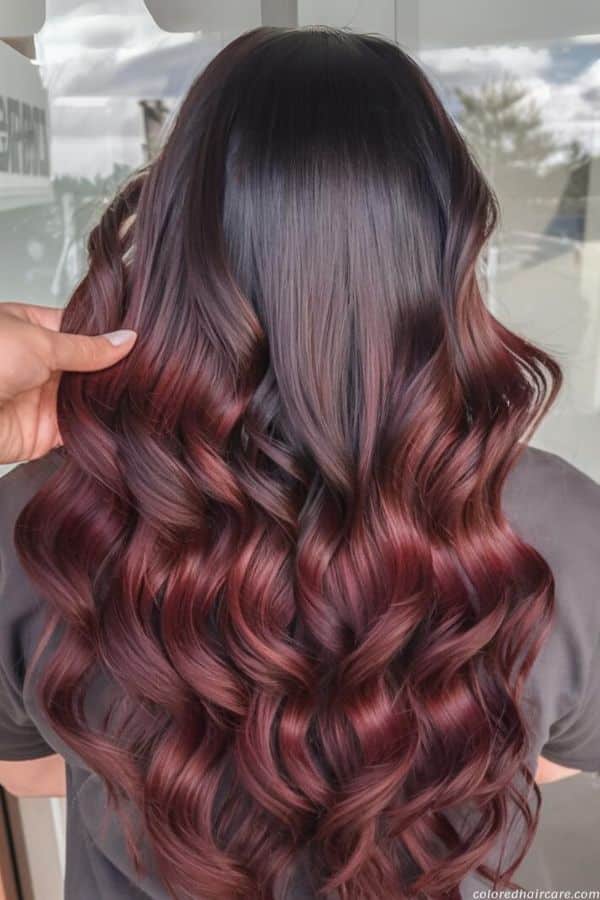 Mahogany ombre fading from dark roots to red-brown curled ends