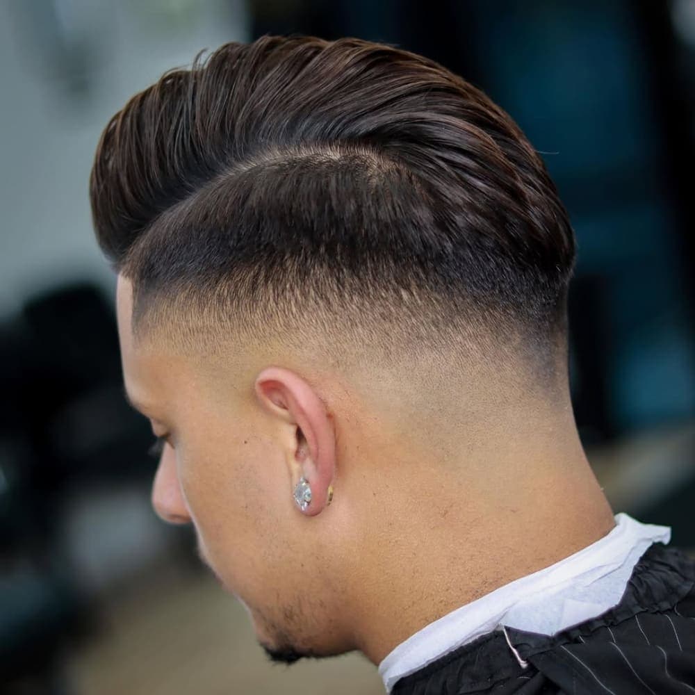 Man with a mid fade comb over haircut
