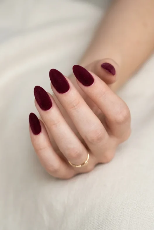 Almond nails in deep burgundy with velvet matte finish