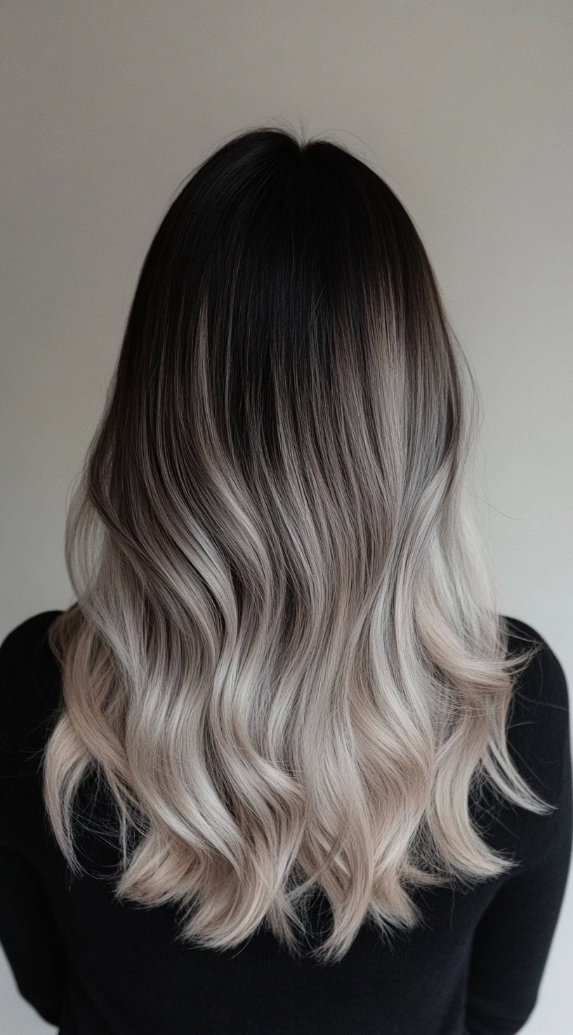Woman with ash blonde balayage melting from dark shadow roots