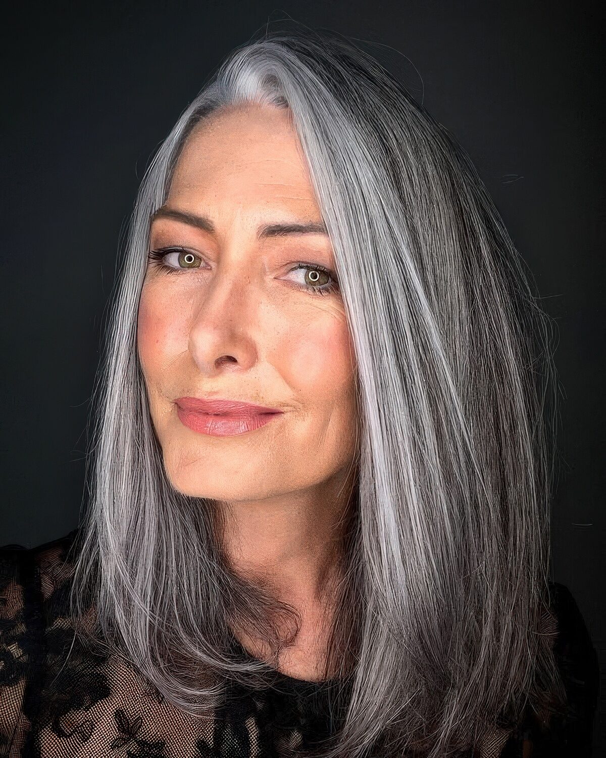 Dark hair with a bright silver money piece around the face