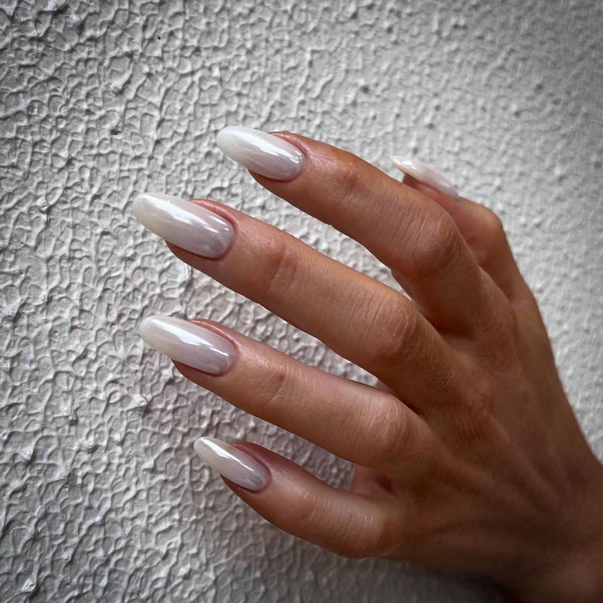 Milky white chrome nails with a soft silver shimmer