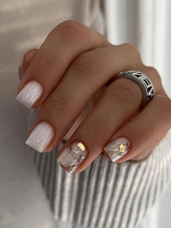 Milky white short square nails with gold foil and marble veining accents