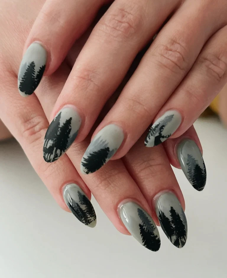 Long almond nails in matte gray with dark evergreen pine tree silhouettes