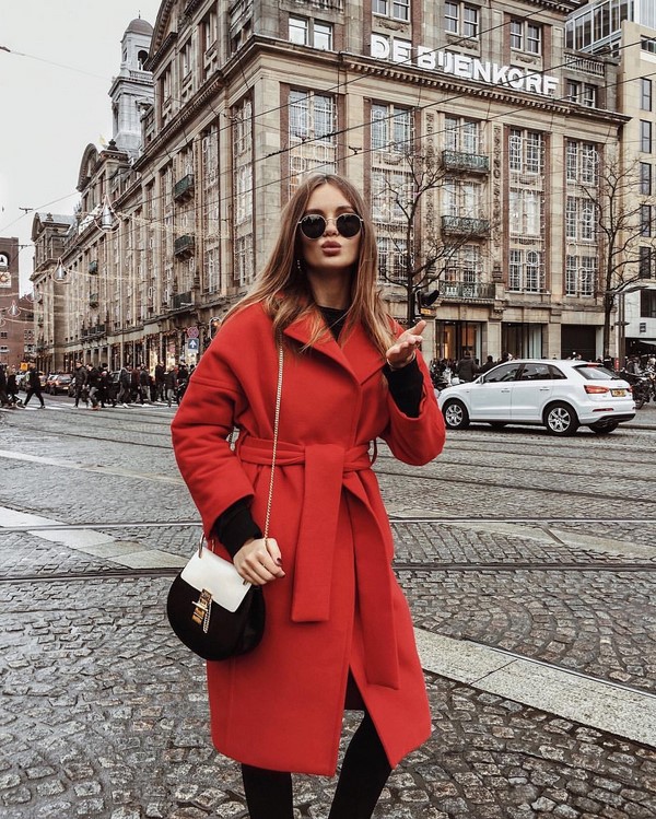 Woman in a tailored winter coat with ankle boots on a city street