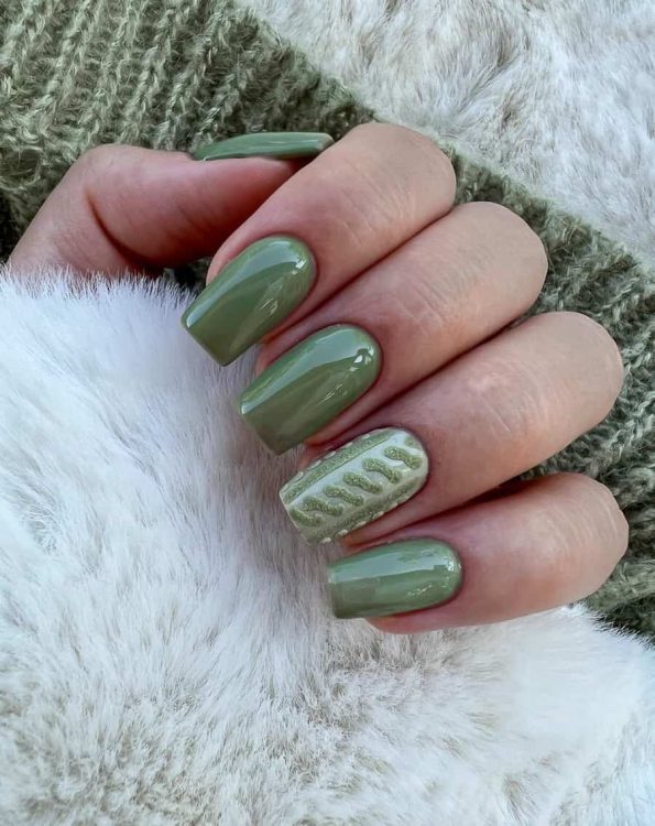 Glossy sage green nails with a cable-knit accent nail