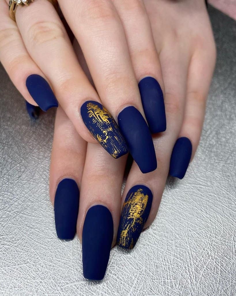 Matte navy coffin nails with gold foil on accent nails