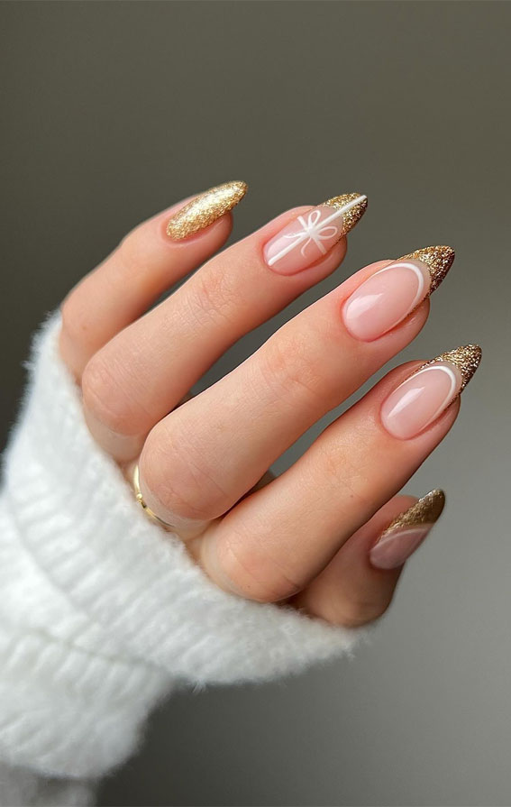 Nude nails with subtle gold glitter accents