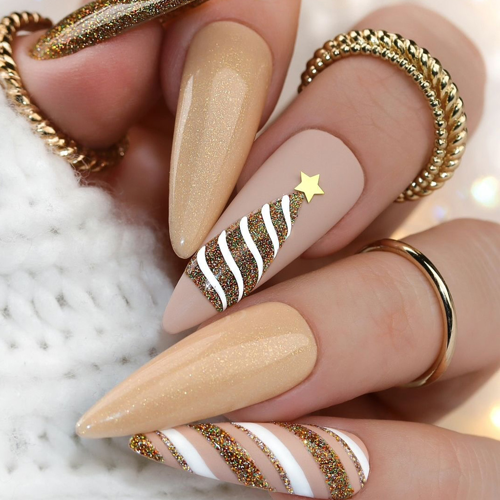 Nude and gold stiletto nails with glitter Christmas tree art and gold star
