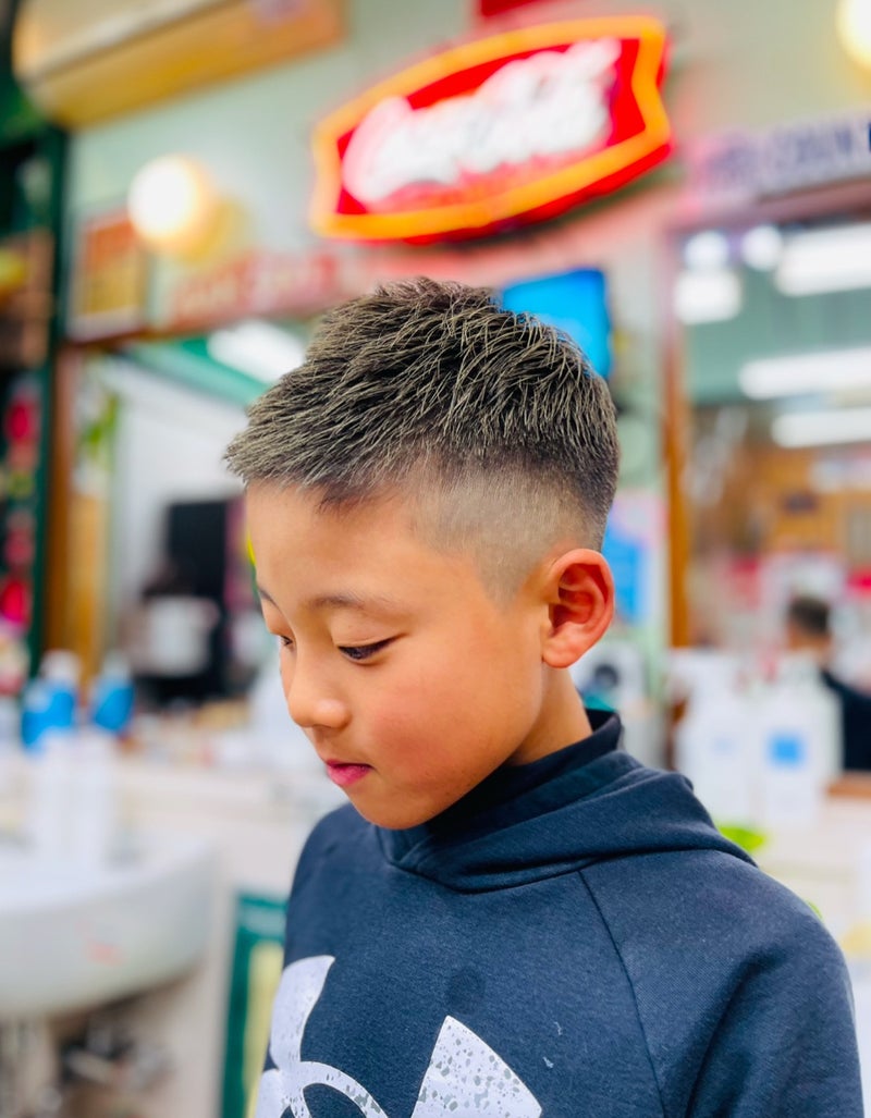 Young boy with a short textured crop haircut and tapered sides