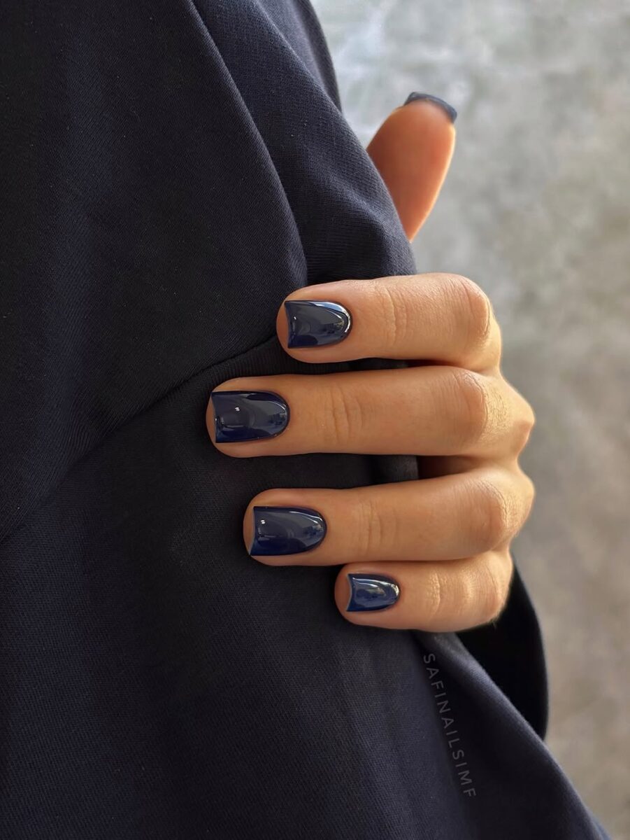 Glossy midnight-navy creme polish on short nails