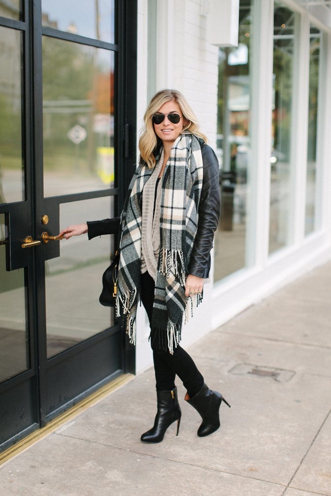 Woman in a neutral winter outfit with a plaid scarf