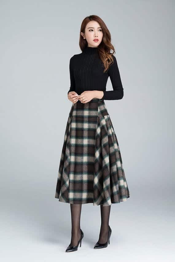 Fitted black turtleneck with a grey and cream plaid midi skirt