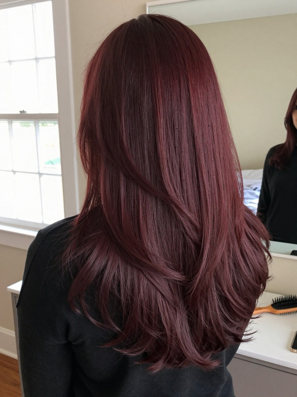 Berry-toned mahogany long layered hair, back view