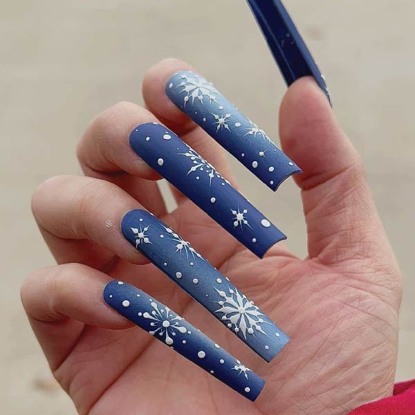 Deep blue long nails with white snowflake art