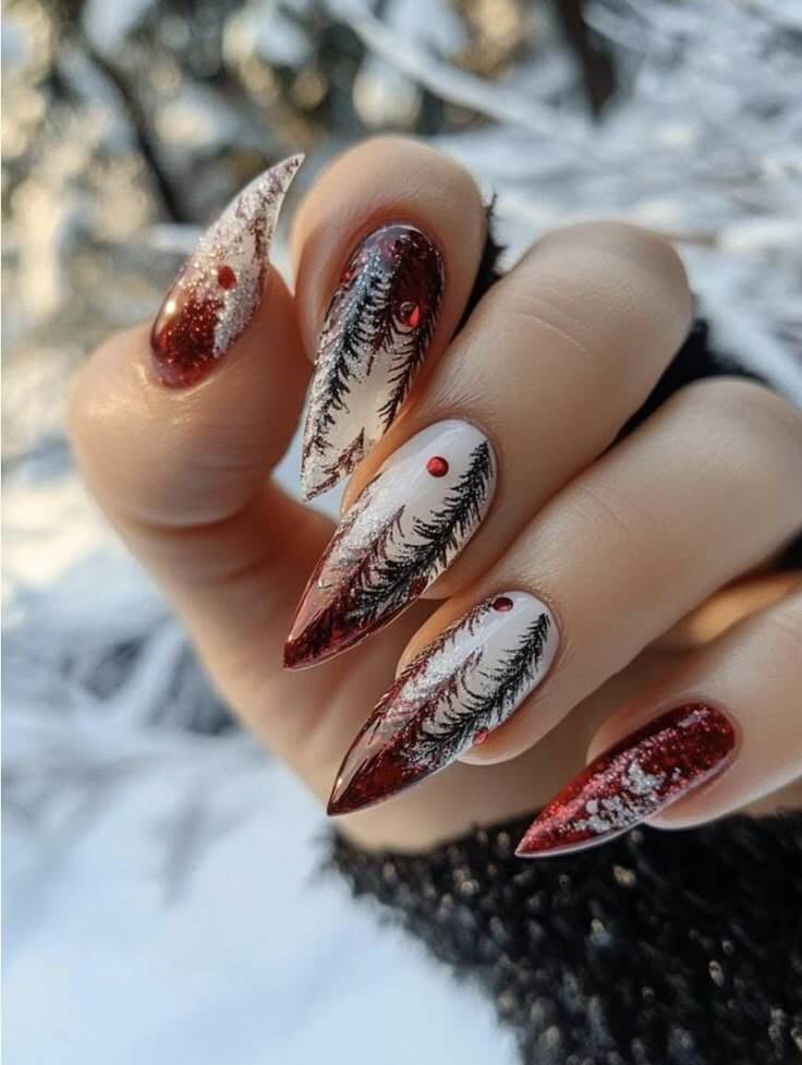 Dark red stiletto nails with white snowy pine trees and red berry dots