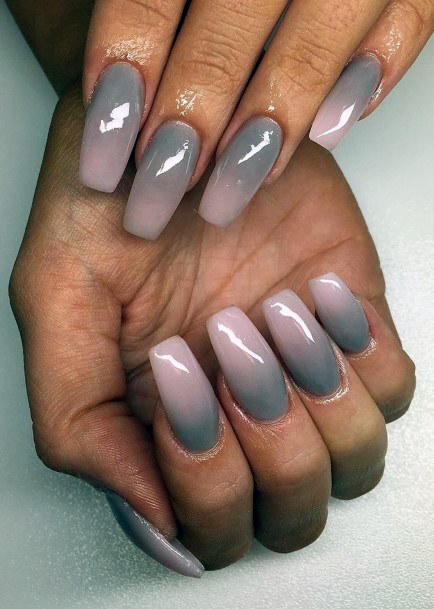 Squoval nails with a pinkish-mauve base fading into cool grey tips with a glossy finish