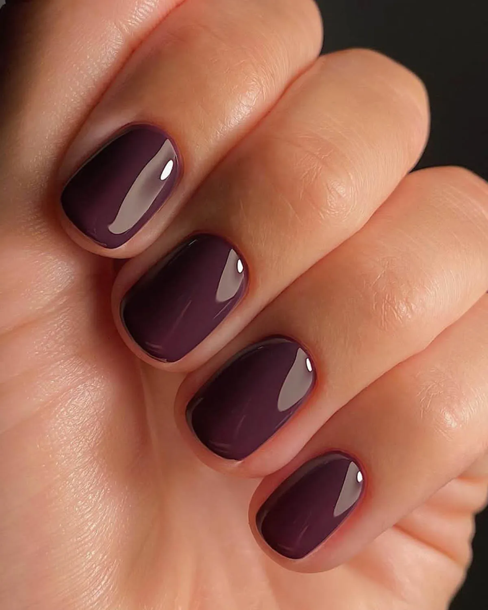 Deep dark plum purple creme polish on short oval nails