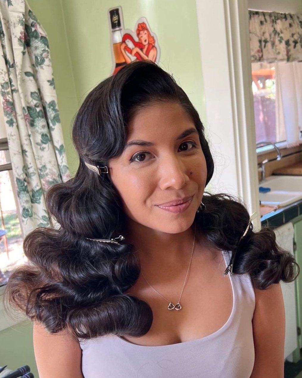 Polished voluminous chocolate brown waves from a deep side part with metallic clips