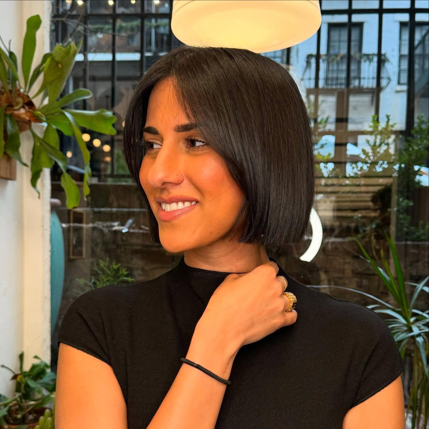 Polished dark brunette chin-grazing Italian bob with soft center curtain