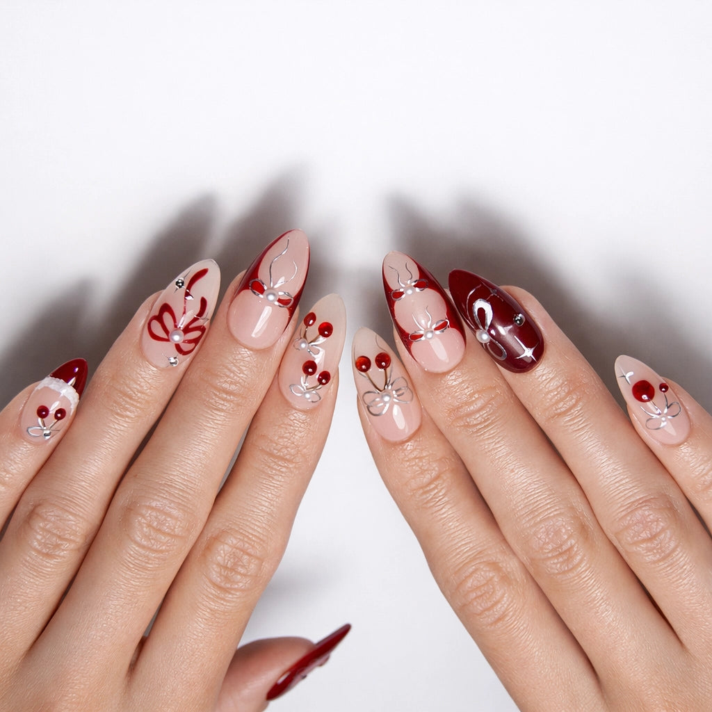 Deep cherry red and nude almond nails with cherry and bow line art