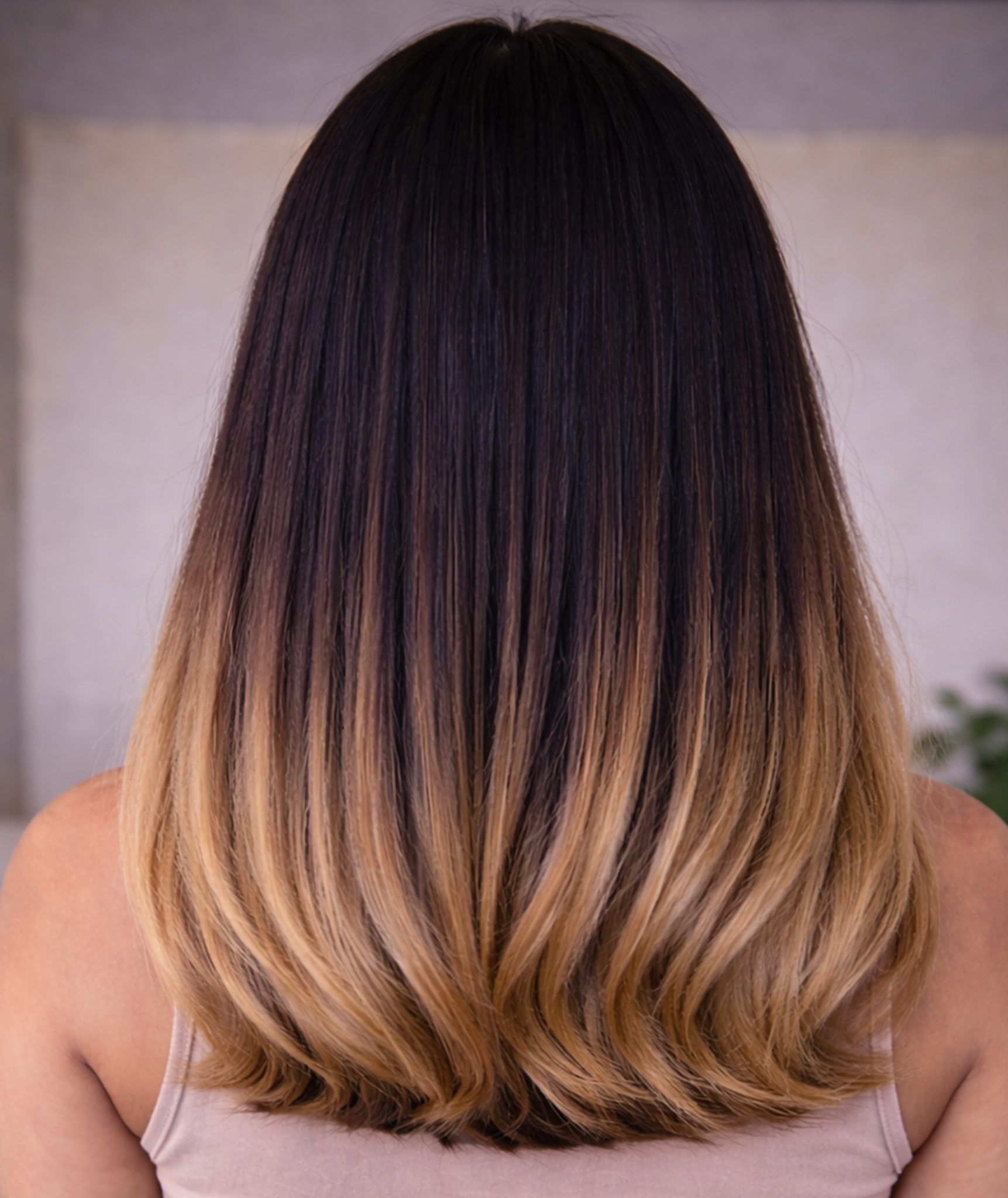 Back view of straight fine hair with a dark brown base melting into honey-blonde ends