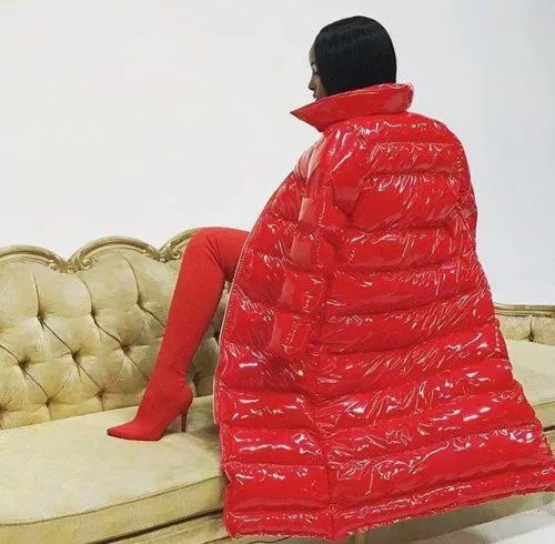 Woman wearing a floor-length red puffer with matching red boots