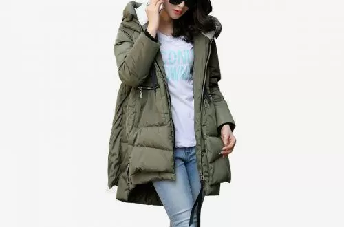 Woman wearing an olive green midi-length hooded puffer jacket