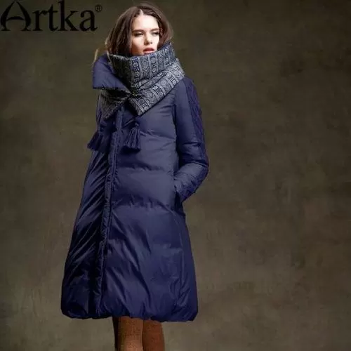 Woman wearing a navy floor-length puffer with a thick patterned scarf