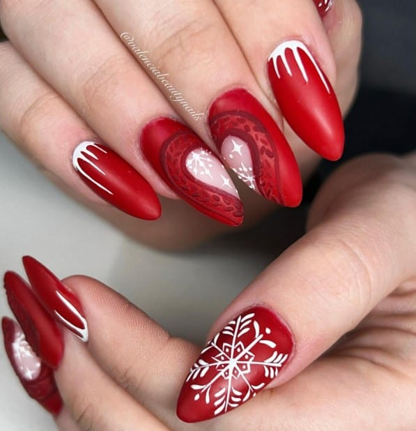 Matte red nails with white snowflake nail art