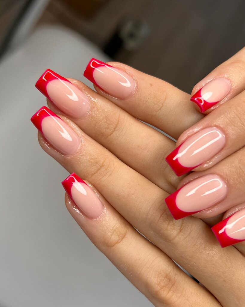 Nude nails with classic red French tips