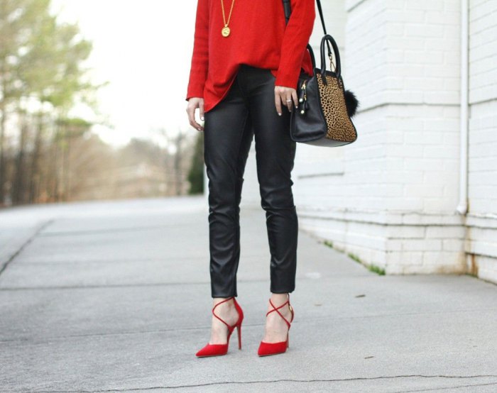 Woman in a red sweater with black leather pants and strappy heels