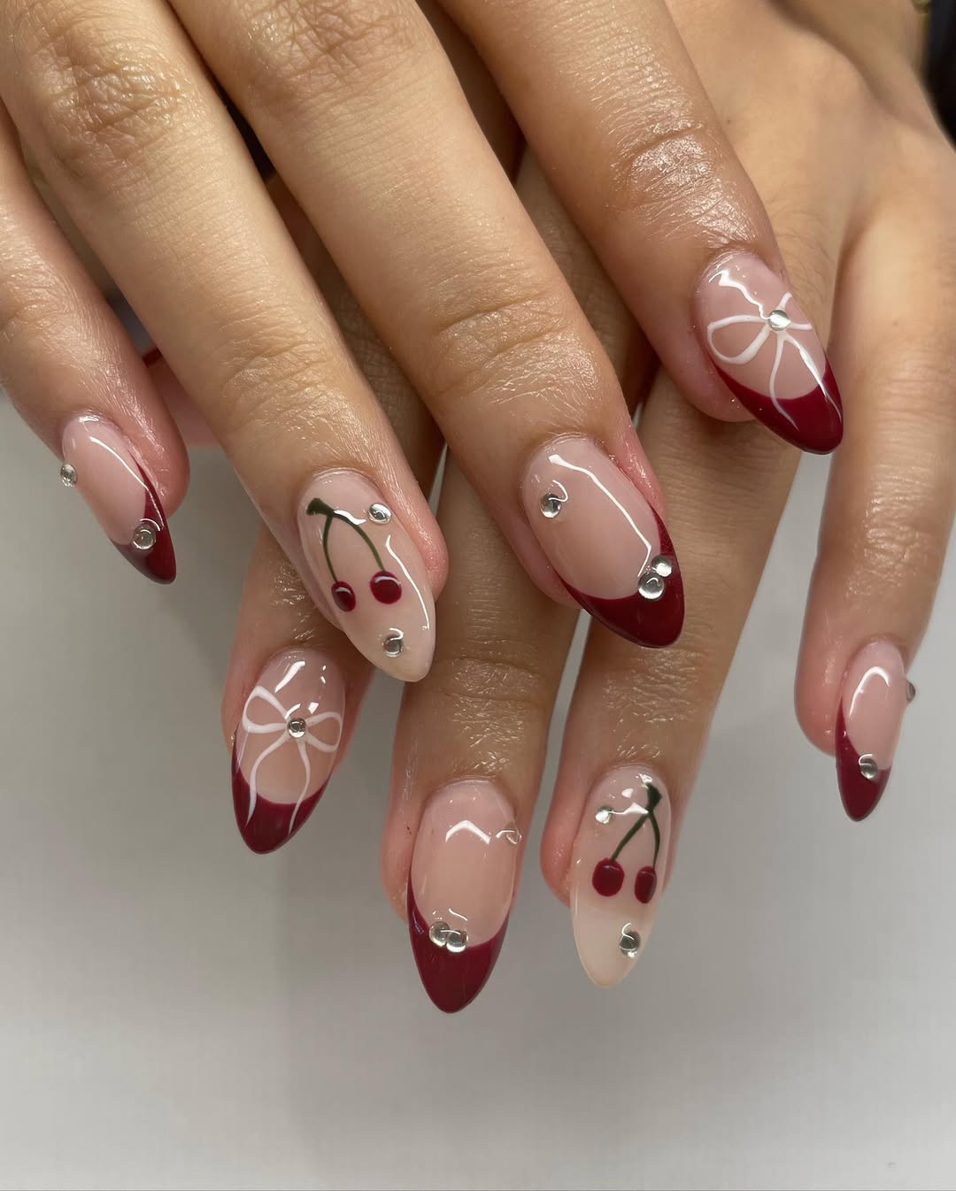 Nude nails with cherry red French tips