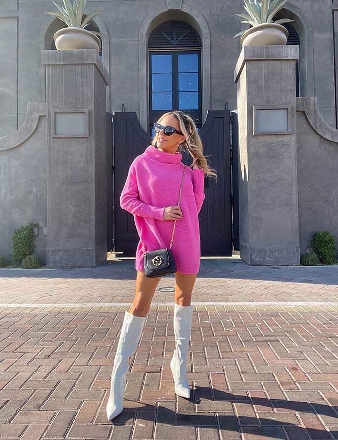 Pink sweater dress with white tall boots
