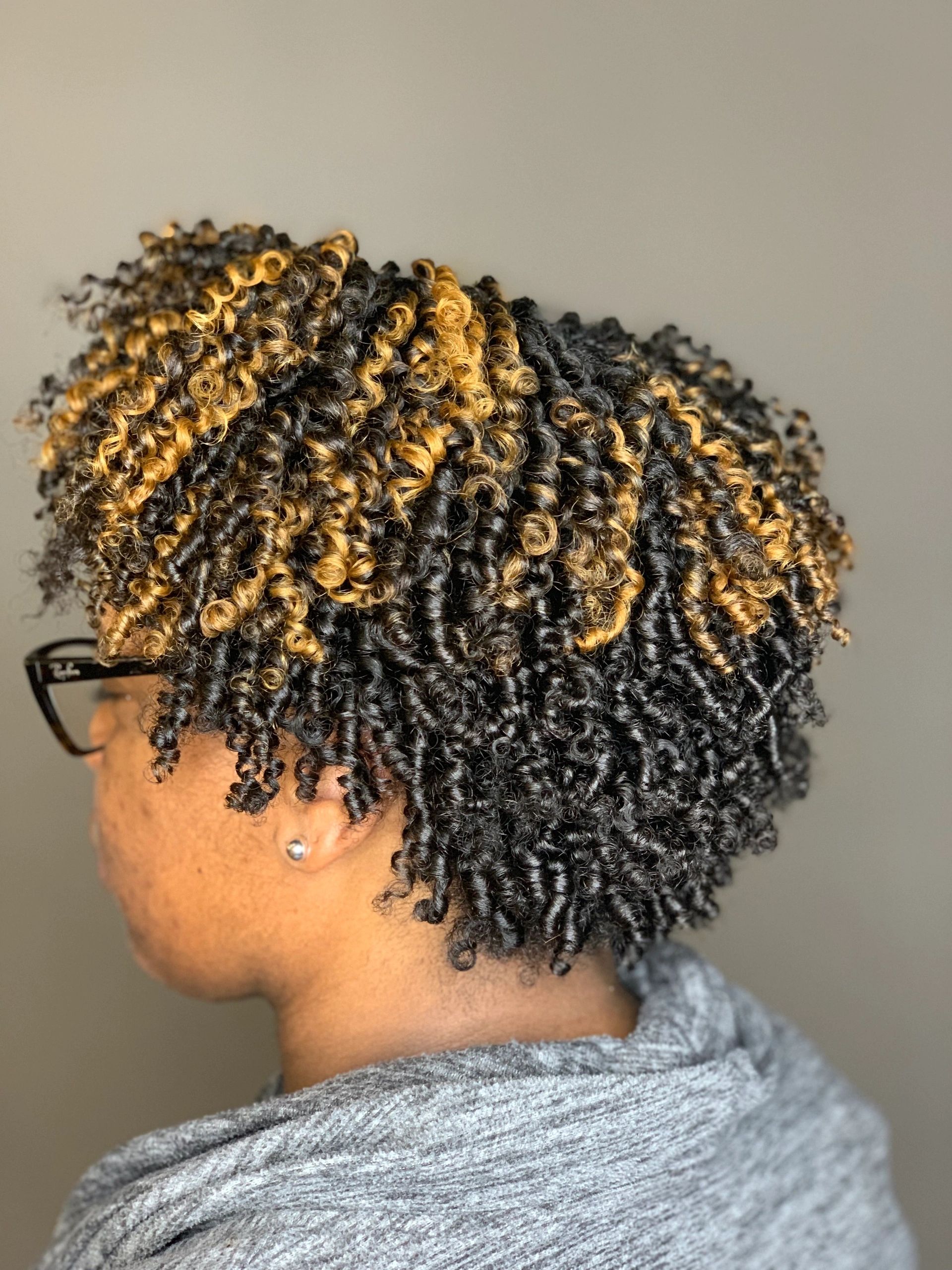 Perm-rod set spiral curls with caramel balayage highlights through the crown