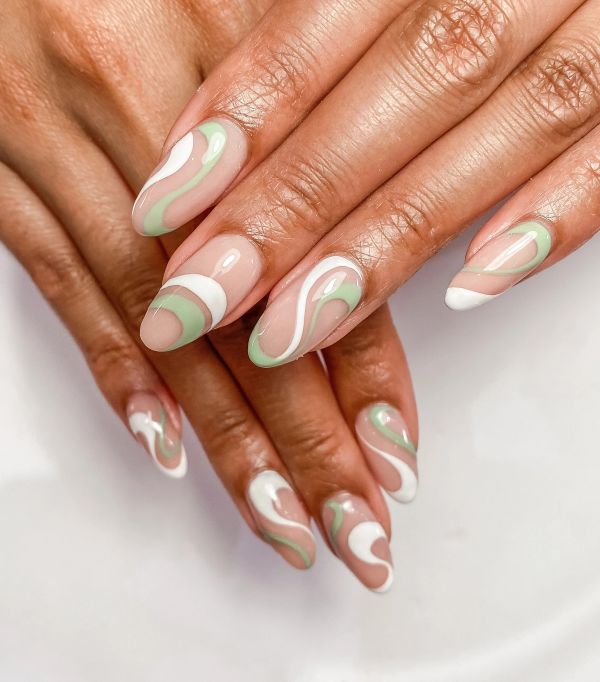 Green swirl line art on nude negative-space nails