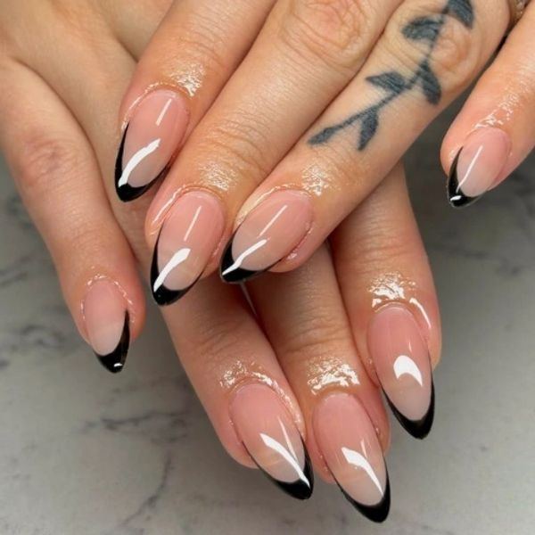 Black French tip nails on a nude base