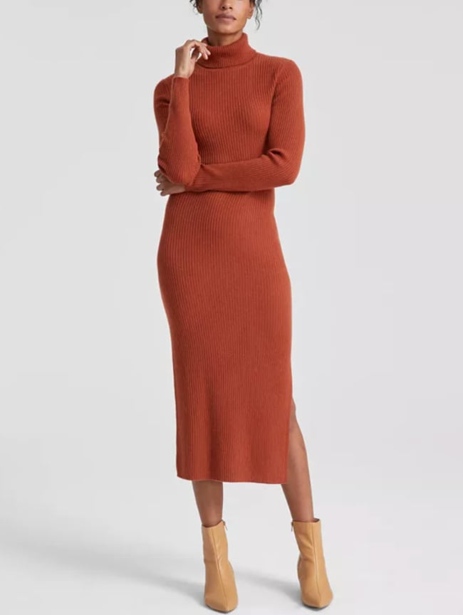 Woman in a rust ribbed turtleneck midi sweater dress with tan ankle boots