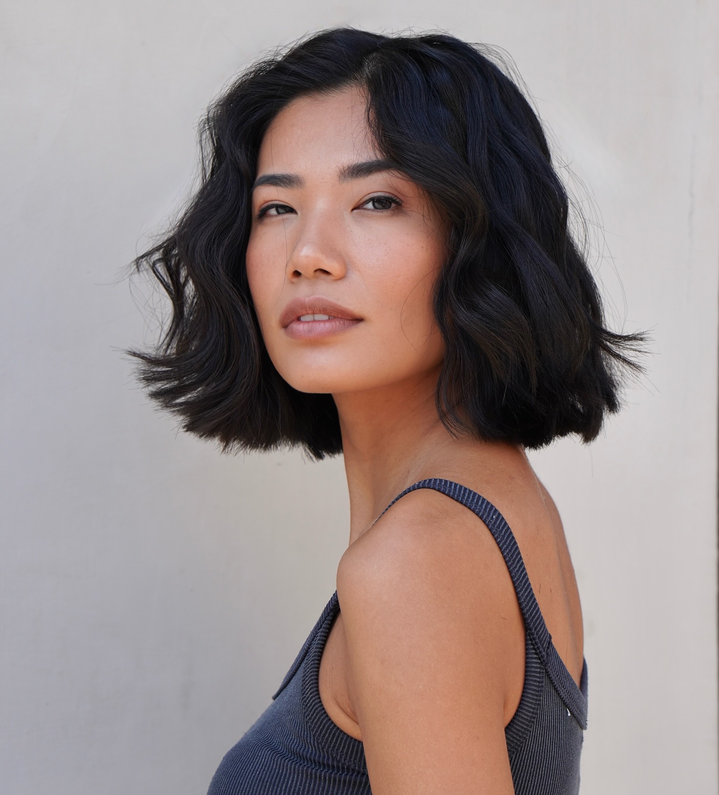 Sculpted wavy Italian bob with slight interior stack and off-center part