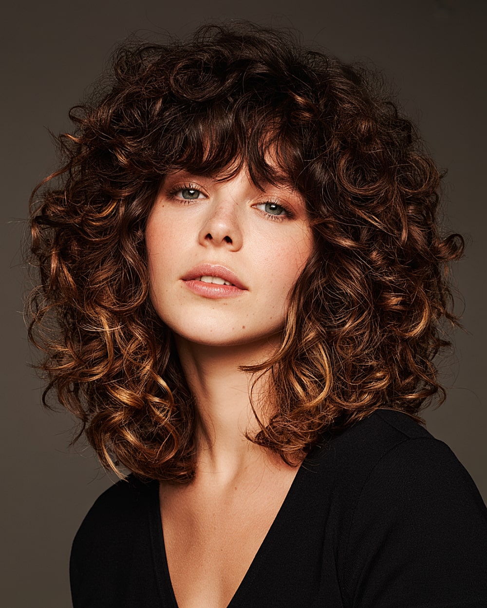 Medium-length curly shag haircut with rounded layers