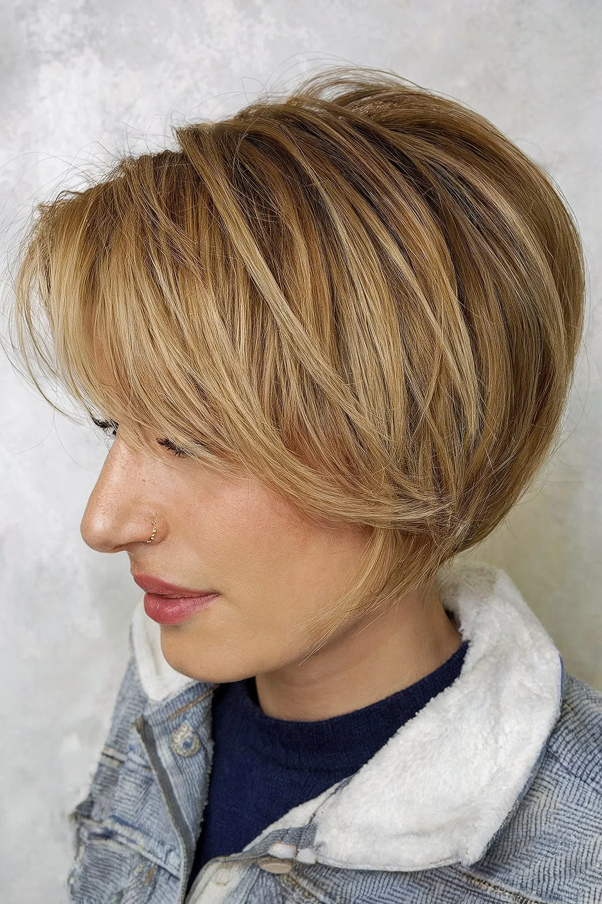 Blonde stacked bob with side-swept bangs