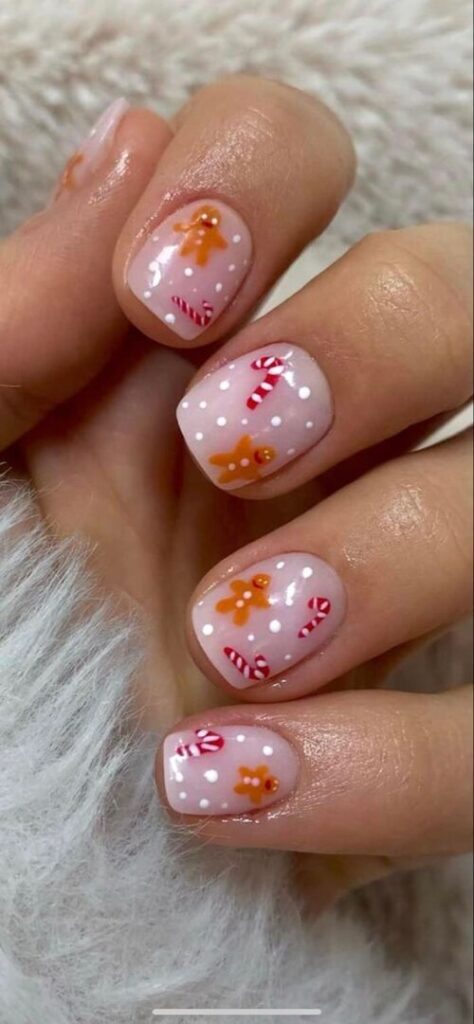 Short nude Christmas nails with gingerbread men and candy cane nail art