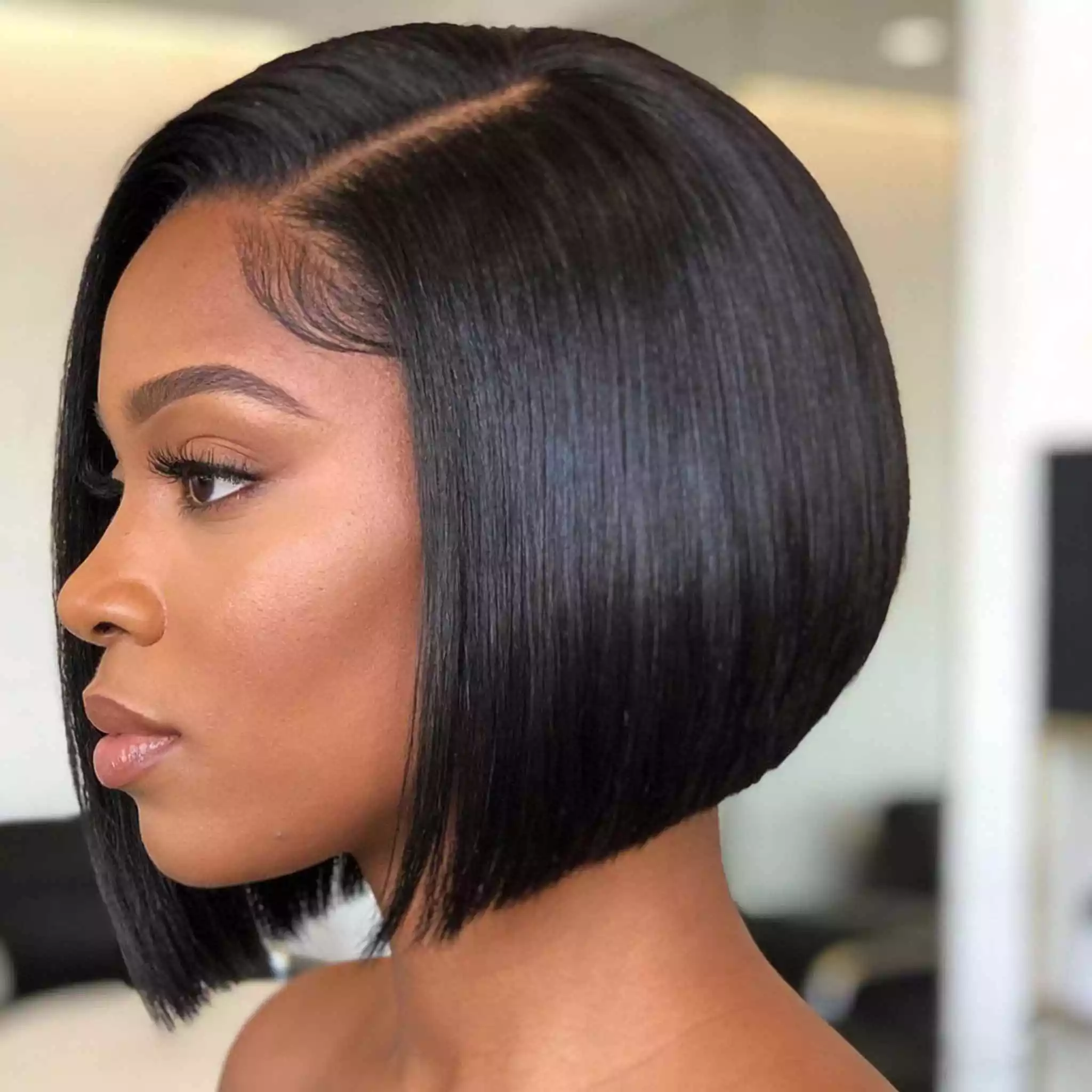 Sleek black bob with a deep side part