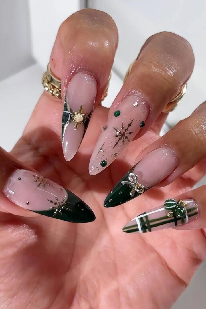 Emerald green French tip nails with gold charms